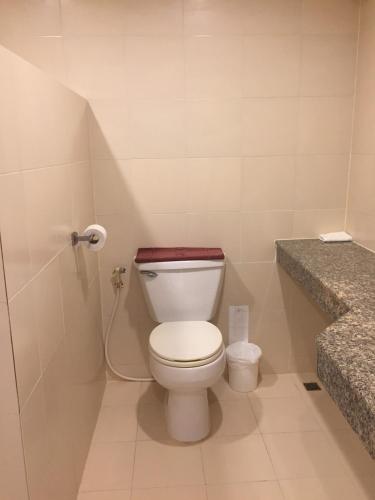 a bathroom with a white toilet and a sink at Rattana View in Phitsanulok