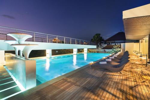 a swimming pool on the roof of a building at Akhyana Village in Jimbaran