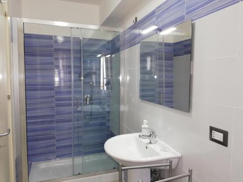 a bathroom with a sink and a glass shower at Akron B&B in SantʼAlessio Siculo