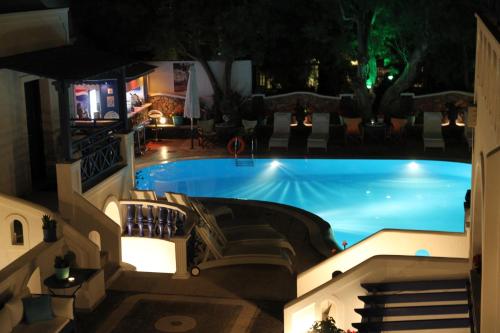 an overhead view of a swimming pool at night at Samson΄s Village in Perissa