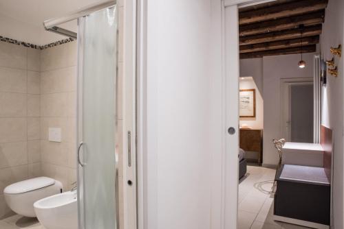 a bathroom with a shower and a toilet and a sink at Venetian Mood private apartment in Venice