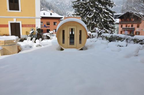 a tiny house in the snow in a yard at Liberty Hotel Malé in Malè