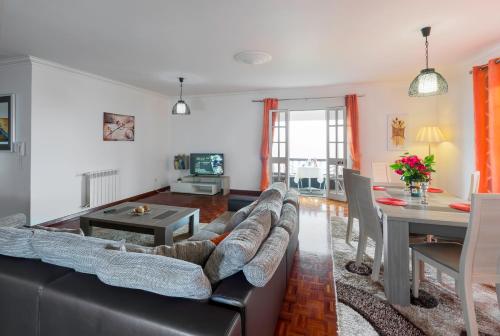 a living room with a couch and a table at Charming Apartments in Funchal - São Gonçalo in Funchal