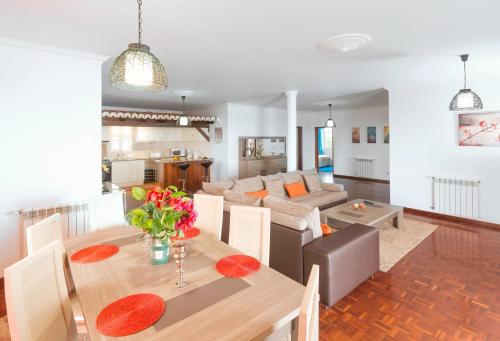 a living room with a table and a couch at Charming Apartments in Funchal - São Gonçalo in Funchal