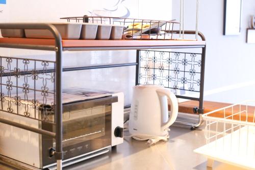 a kitchen with a counter with a appliance on it at Guest House Re-worth Yabacho1 202 in Nagoya