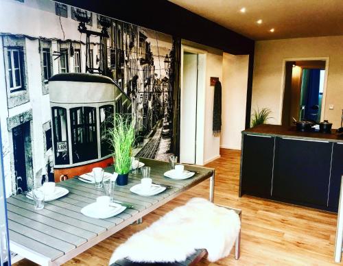 a dining room with a table and a train mural at 5 Zimmer Loftstylewohnung in Bad Wörishofen in Bad Wörishofen