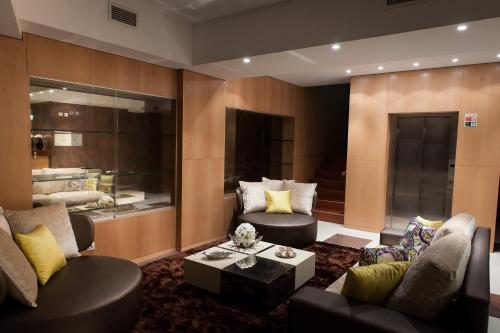 a living room with two couches and a table at Mondim AL & Spa in Mondim de Basto