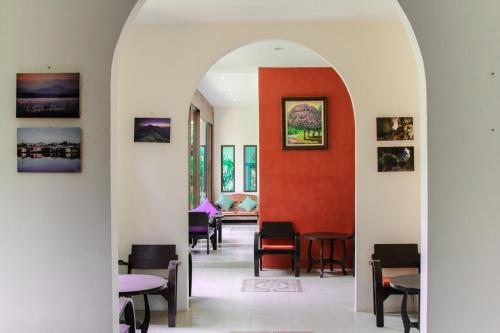 an archway leading into a dining room with tables and chairs at The Journey House Lifestyle Boutique Hotel in Kanchanaburi