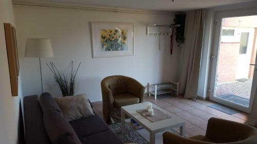 a living room with a couch and a table at Vogler Lothar in Neustadt in Holstein