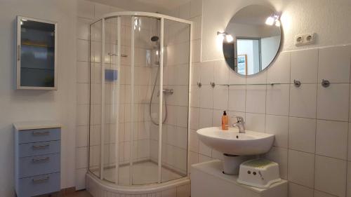 a bathroom with a shower and a sink and a mirror at Vogler Lothar in Neustadt in Holstein