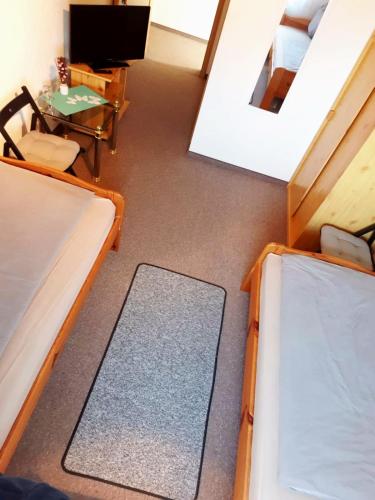 a room with three beds and a table at Havelschatz in Bensdorf