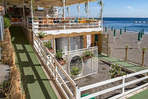 a restaurant on the beach with the ocean in the background at Angelina Residence in Maiori