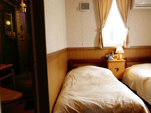 Кровать или кровати в номере Pension Yumekukan