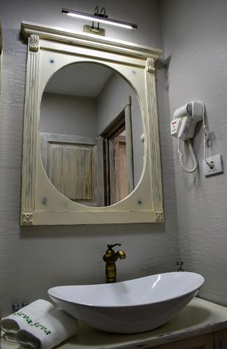 a bathroom with a sink and a mirror at Vila Seva in Vatra Dornei