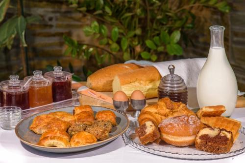a table with two plates of pastries and bread at Pyrgos Hotel in Ouranoupoli