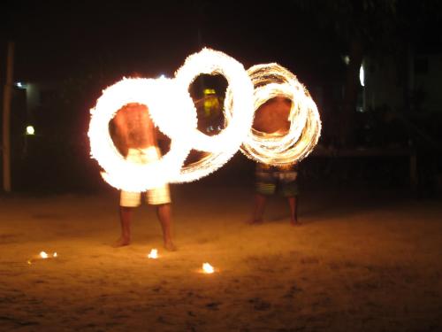 two people standing in the sand with a fire symbol at Bamboo Backpackers in Nadi