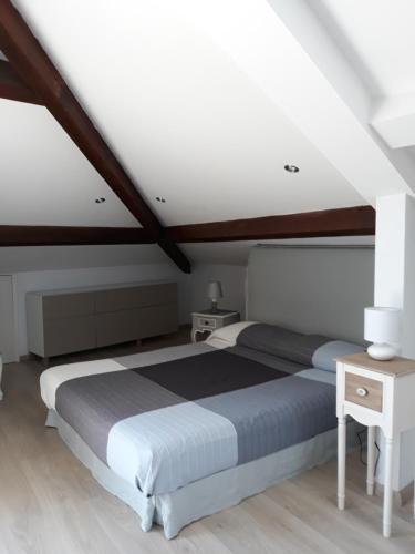 a bedroom with a bed and a wooden ceiling at Skyline, Casa Vacanze in Savona