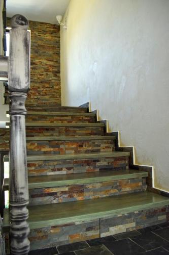 a set of stairs with a metal pole next to it at Vila Seva in Vatra Dornei