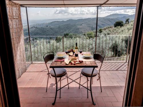 a table and chairs on a balcony with a view at Agriturismo La Forra in Cavriglia