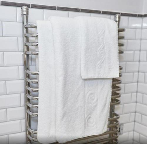 a towel rack with white towels in a bathroom at Red Lion Hotel by Greene King Inns in Fareham