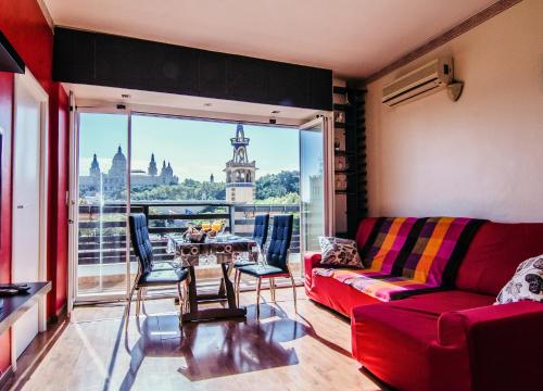 a living room with a red couch and a table at Unique Cozy Scenic Penthouse in Barcelona