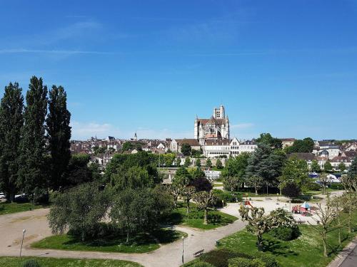 a view of a park with a building in the background at ibis budget Auxerre Centre in Auxerre