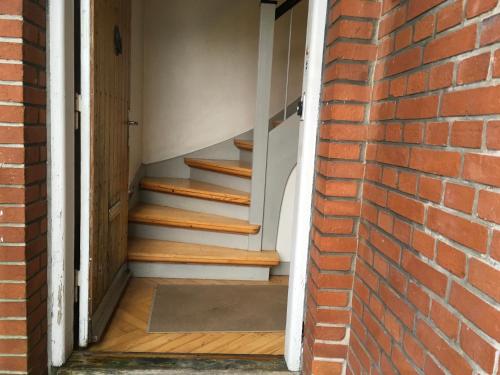 a brick wall with a stairway leading to a door at Kongebrogade 77 in Kolding