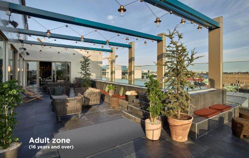 a patio with chairs and plants on a building at Downtown Camper by Scandic in Stockholm