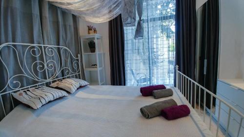 a white bed with two pillows on it in a bedroom at OpenSky Lux in Kallithea Halkidikis