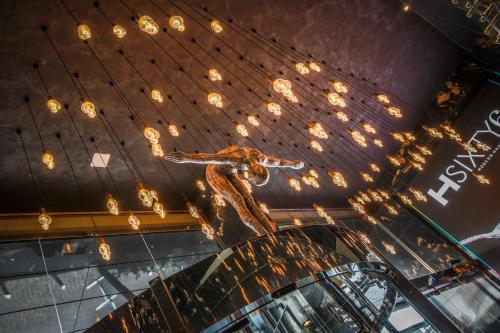 a sculpture of a woman on a ceiling with lights at H Hotel & SPA - Adults Only in St Julian's