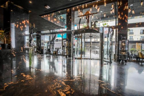 a view of the lobby of a building with lights at H Hotel & SPA - Adults Only in St Julian's