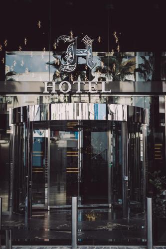 a hotel entrance with a sign on top of it at H Hotel & SPA - Adults Only in St Julian's