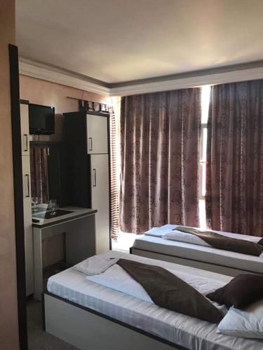 a hotel room with two beds and a sink at Sport Residence in Bacău