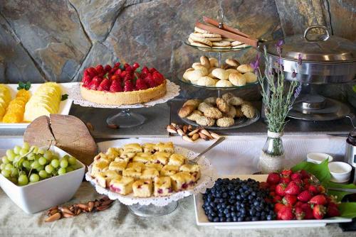 a table with many different types of fruits and desserts at Hotel Terraza Suite in Villarrica