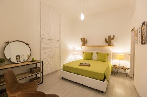a bedroom with a bed and a mirror and a chair at Lovely New home, Trastevere! in Rome