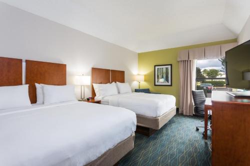 a hotel room with two beds and a desk at Holiday Inn Express & Suites Wilmington-University Center, an IHG Hotel in Wilmington