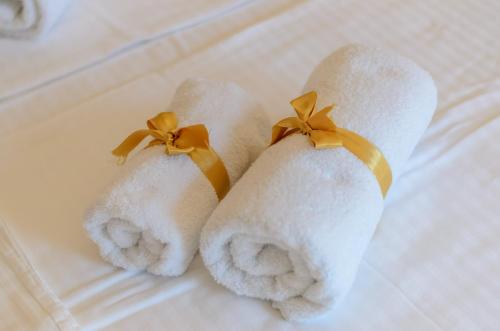 two towels with orange bows on a bed at Sava Smart Apartment in Belgrade