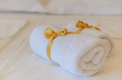 a towel with a yellow bow on top of it at Sava Smart Apartment in Belgrade