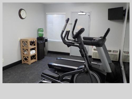 a room with a gym with two exercise bikes at Clarion Pointe Indianapolis Northeast in Castleton