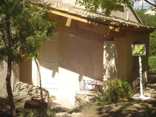 a porch of a house with a door and a chair at La Maison St Gervais in Saint-Gervais