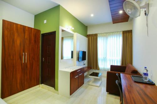 a room with a living room with a table and a couch at MAZUS INN in Vythiri