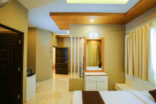 a bedroom with a bed and a large mirror at MAZUS INN in Vythiri