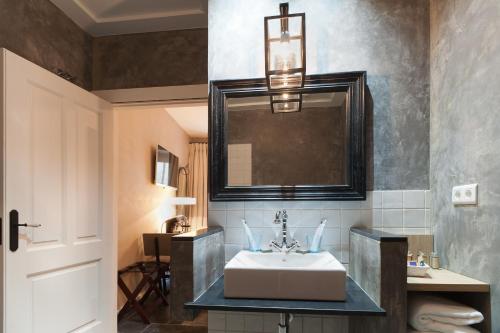 a bathroom with a sink and a mirror at Boutique Hotel Casa Granados in Tossa de Mar