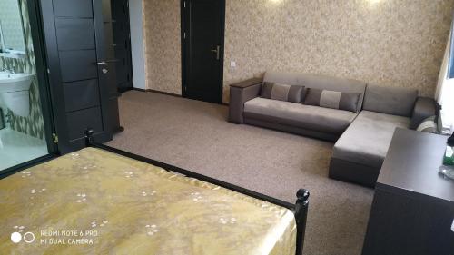 a living room with a couch and a table at Evim Otel in Zaqatala
