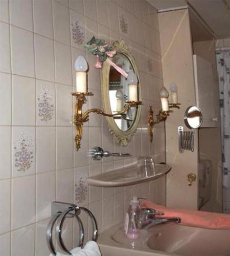 a bathroom with a sink and a mirror at Haus Martina in Siegsdorf