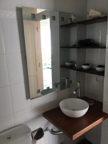 a bathroom with a bowl sink and a mirror at White House Suite in Los Llanos de Aridane