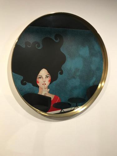 a round mirror with a picture of a woman at Rozmaryn Hotel B&B in Rakovník