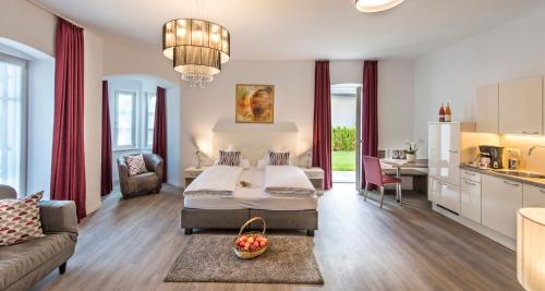 a large bedroom with a bed and a kitchen at Villa Caldarum in Caldaro