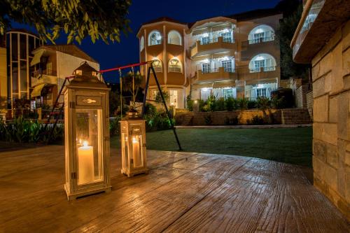 two lights on a wooden deck in front of a building at Hotel Agios Thomas in Ligia