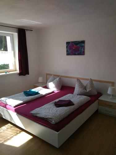 a bedroom with two beds and a window at Greizer Kammhütte Gaststätte & Pension in Klingenthal